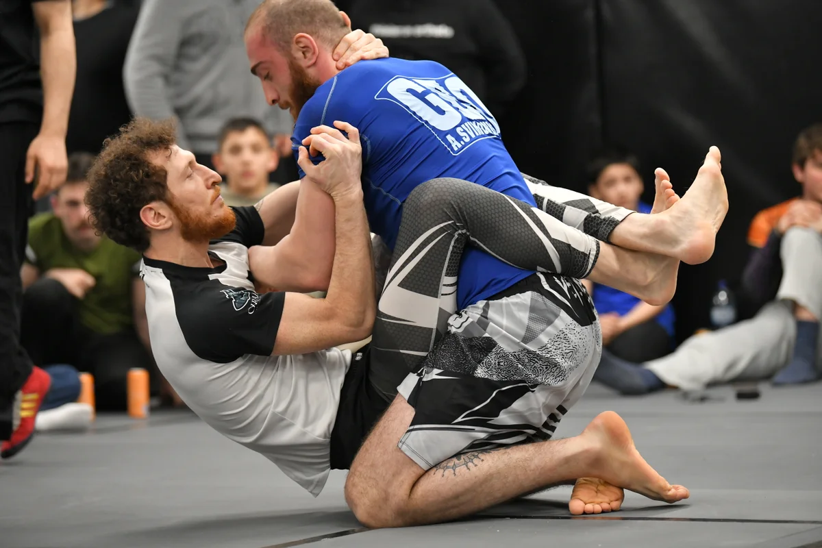 Adult grapplers in competition preparation drills