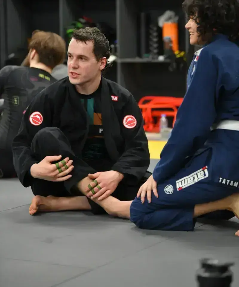 BJJ athletes reviewing technique between rounds