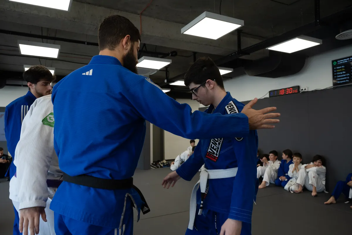 BJJ coach giving technical instruction on the mats