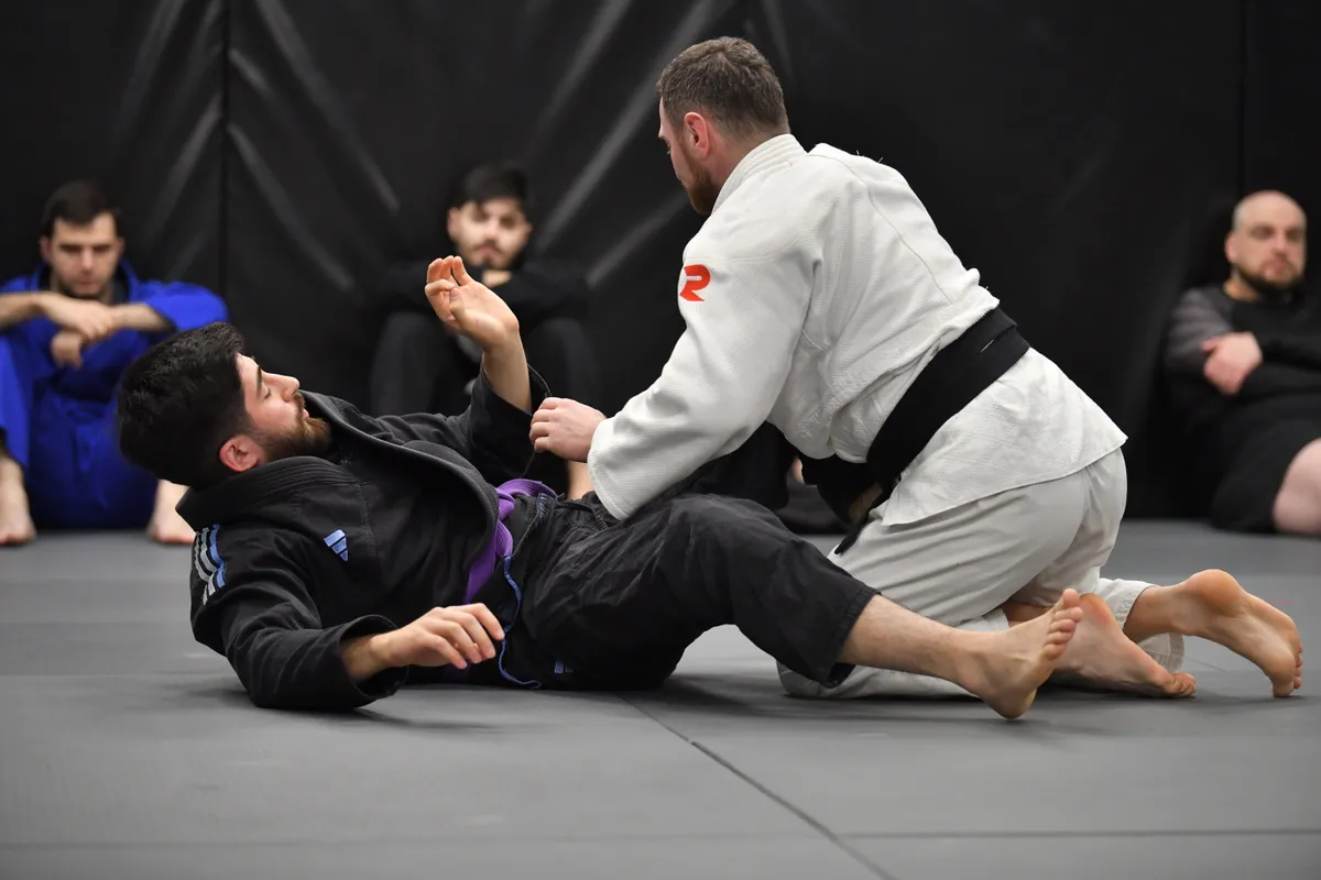 Adult BJJ training session focused on grappling fundamentals
