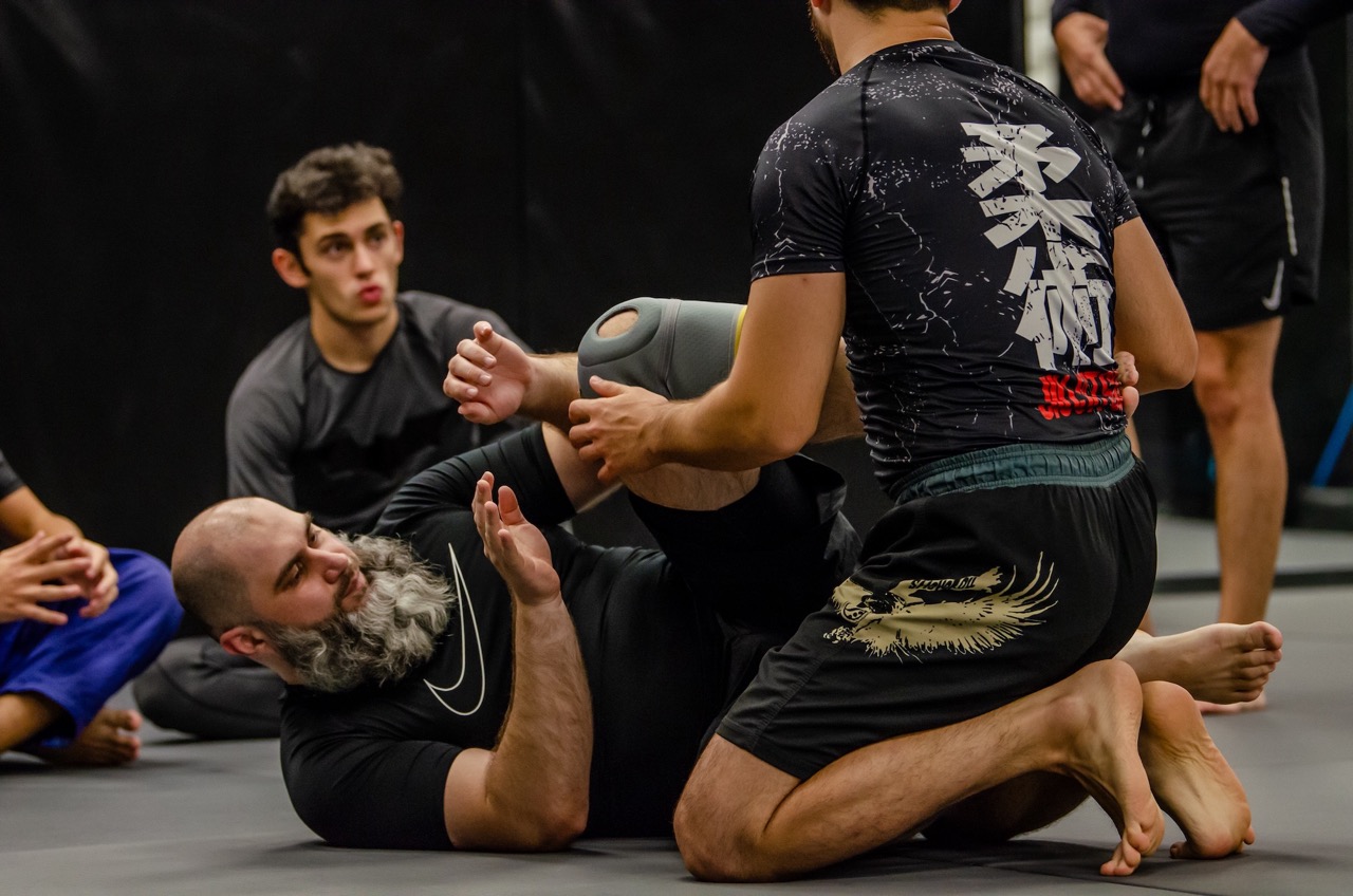 Grapplers working a live round during BJJ camp training