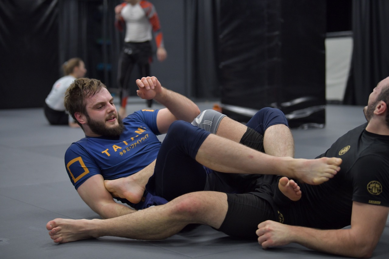 No-gi grappling practice with coach supervision