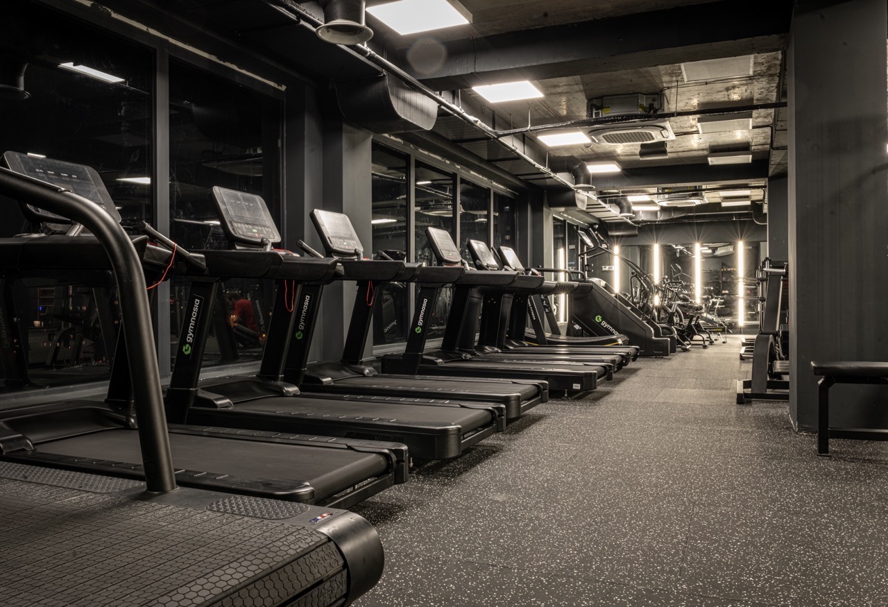Training area with strength equipment and open mat space