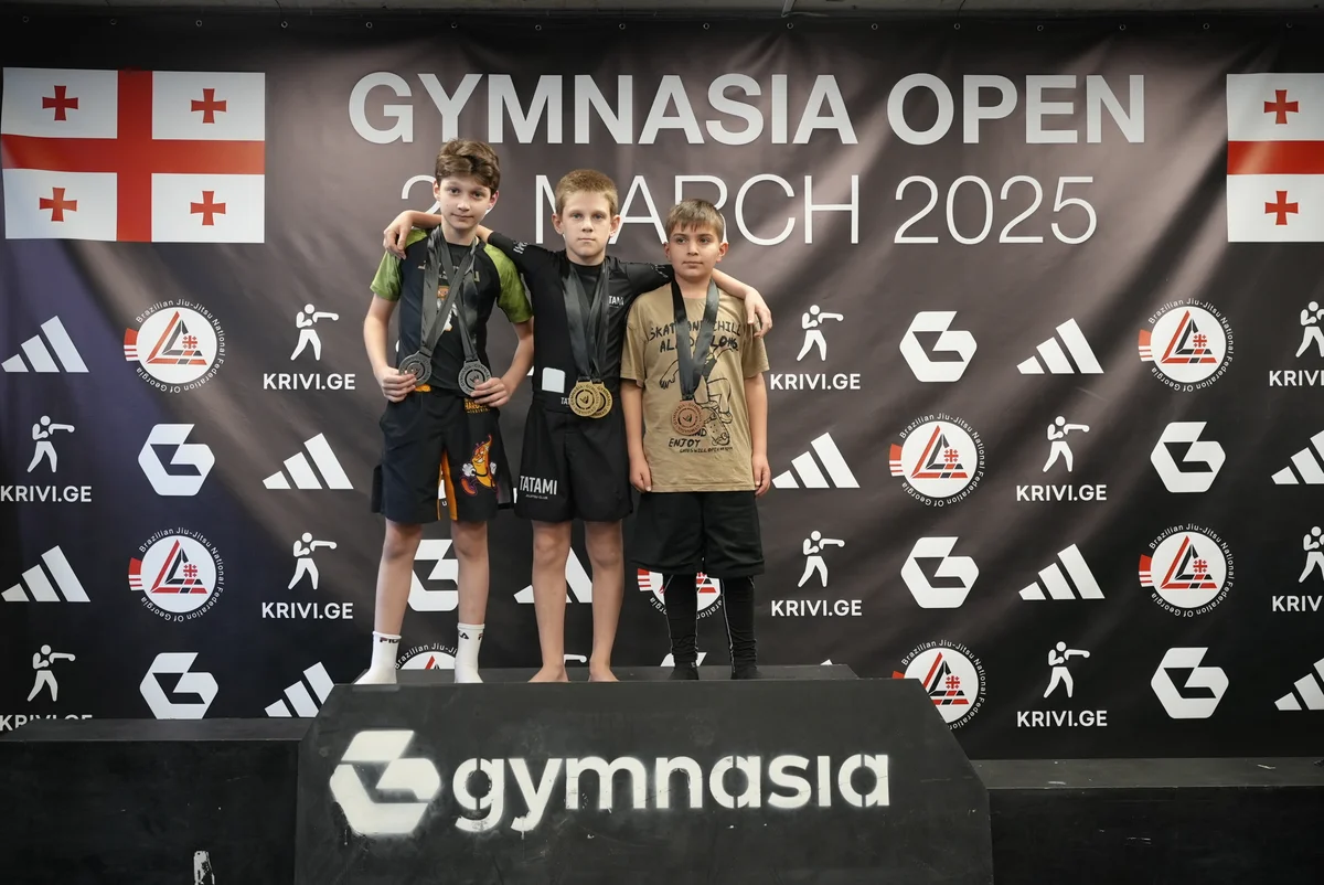 Medal-winning grapplers posing after a competition session