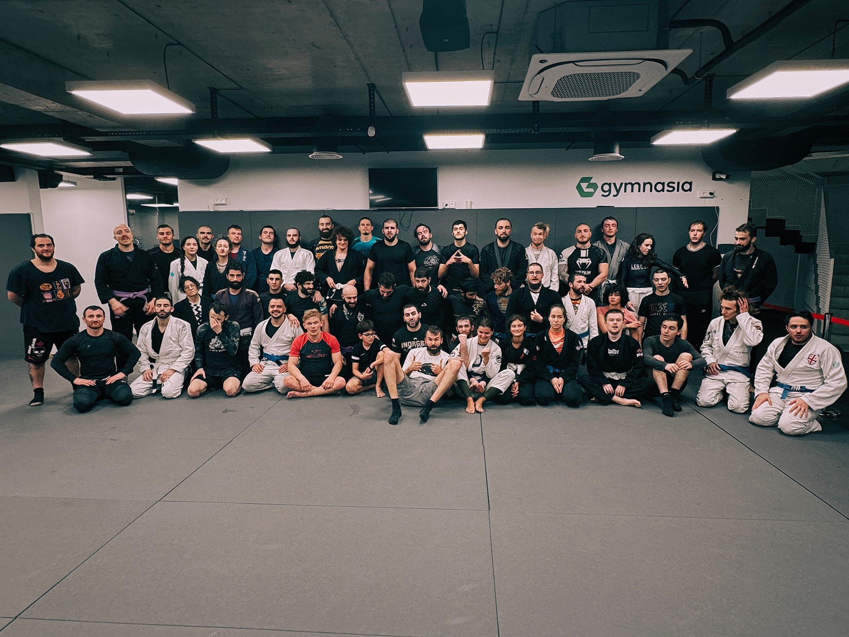 Group photo of BJJ camp athletes and coaches